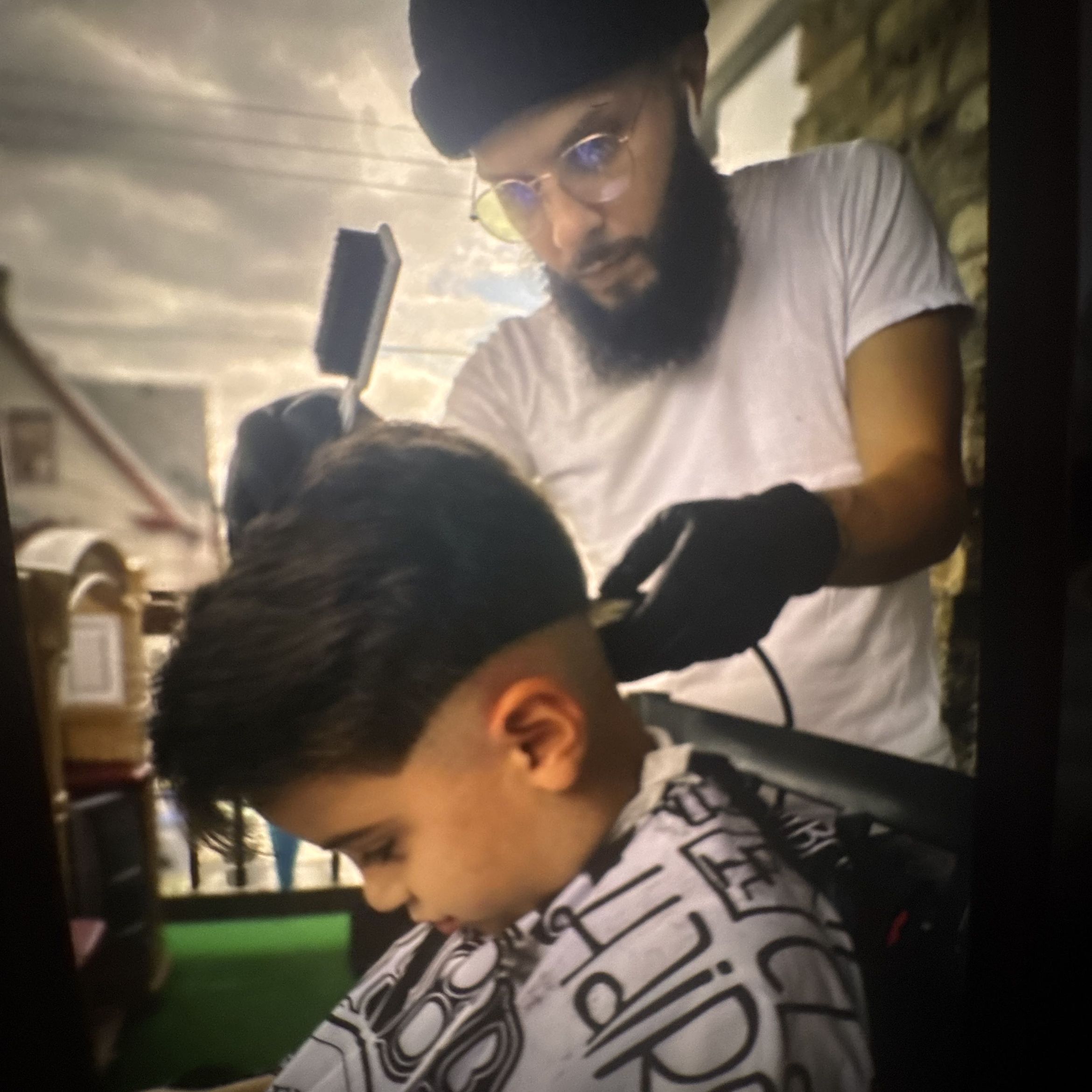 Abe the barber working with a client