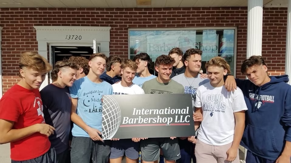 Local community group outside International Barbershop in Brookfield